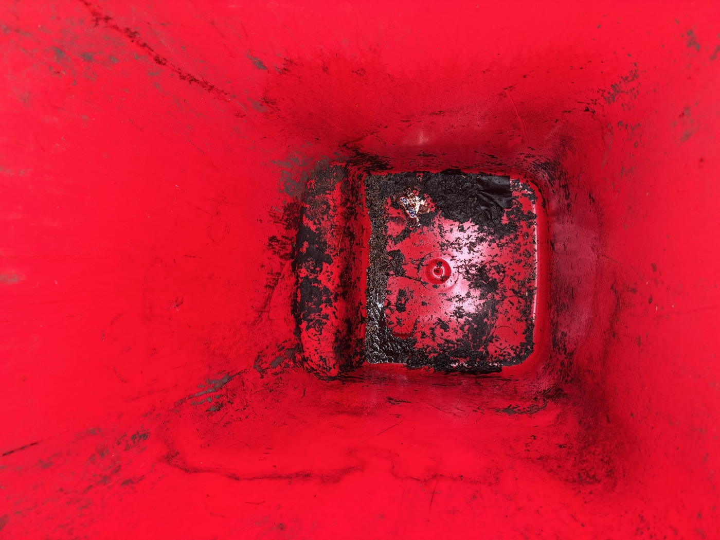 Dirty red bin interior before cleaning