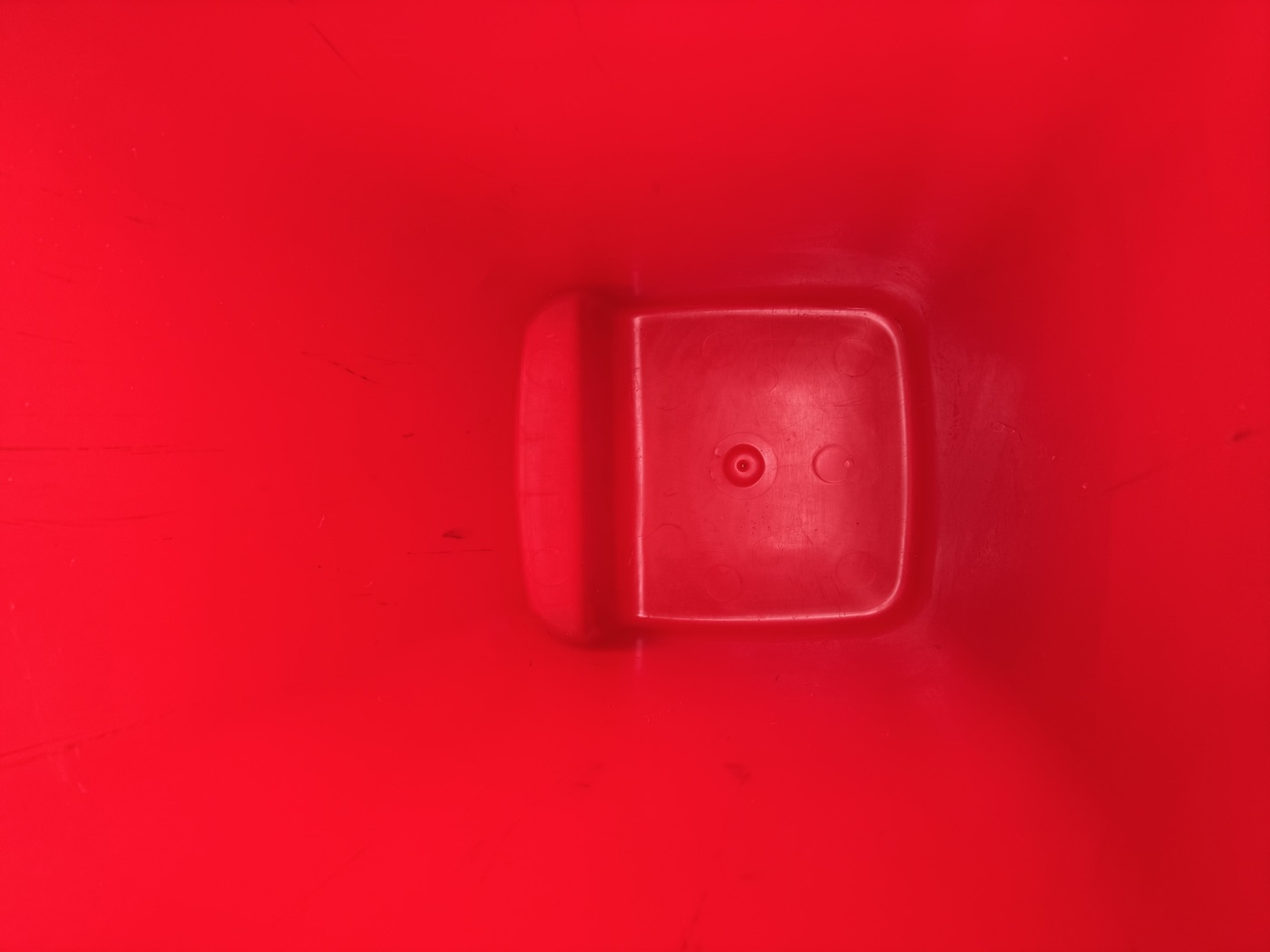 Spotlessly clean red wheelie bin interior