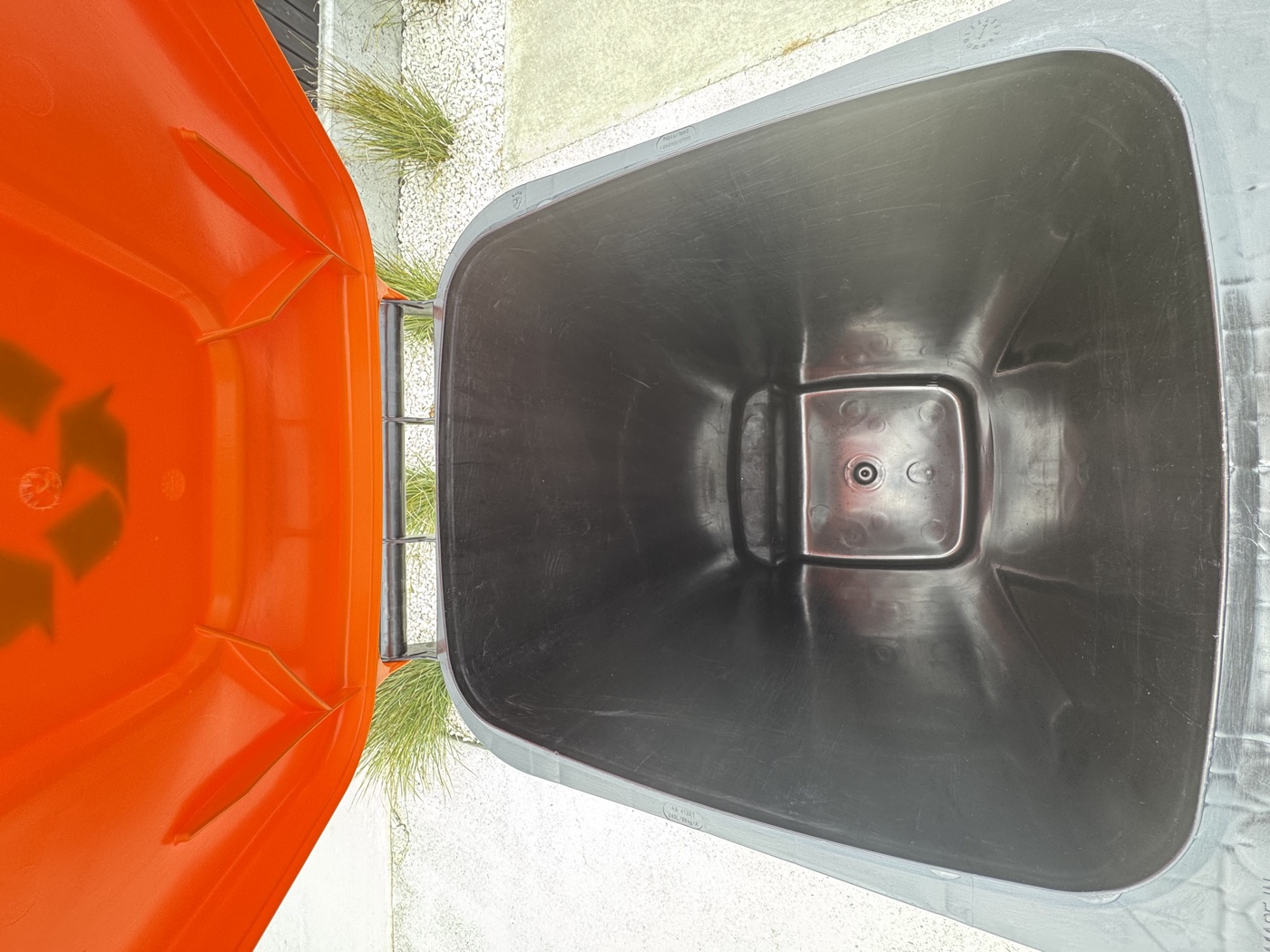 Clean orange and black wheelie bin after professional service